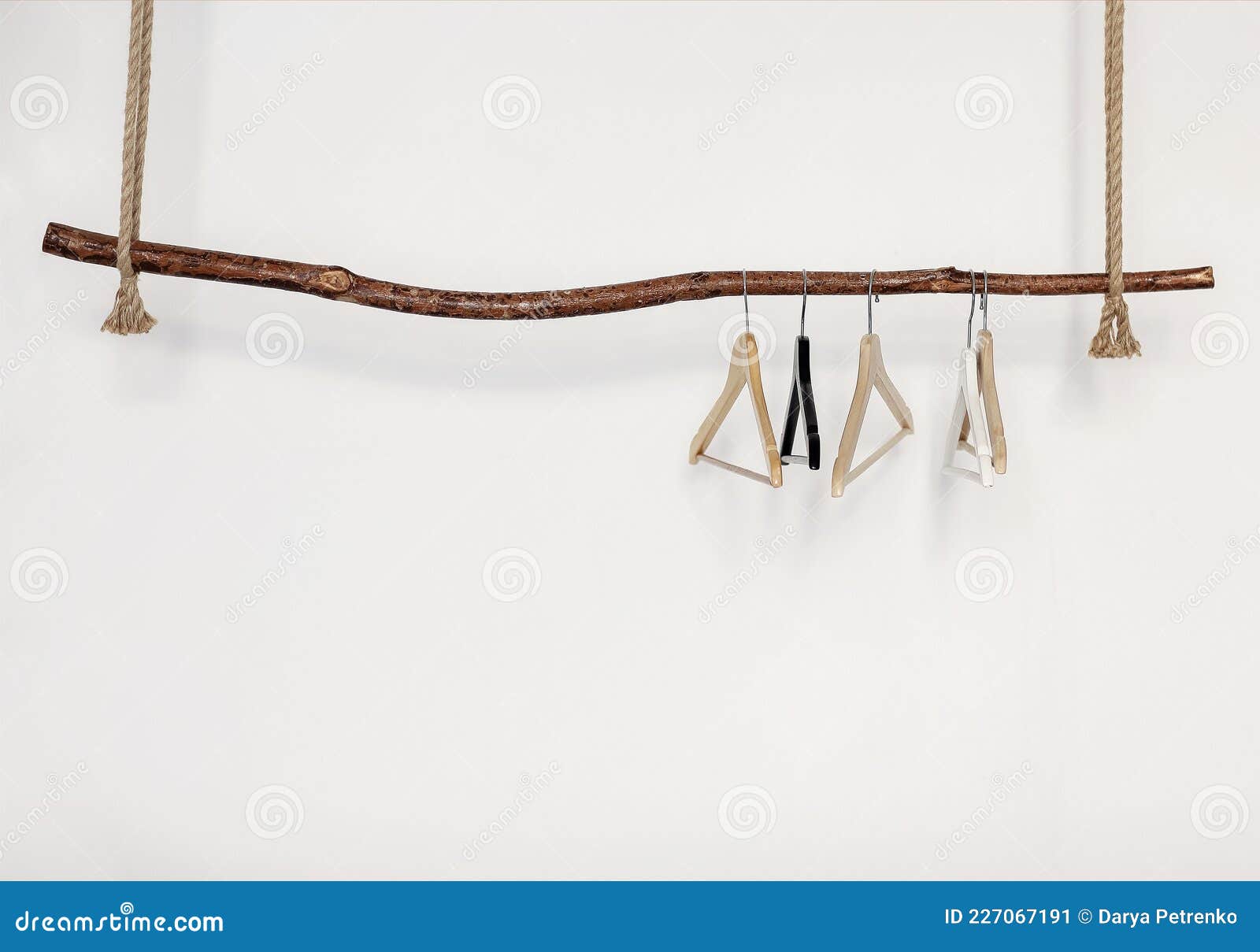 Five Empty Clothes Hangers Hanging on Wooden Rustic Style Rod on Thick Rope,  Isolated Over White Wall Stock Image - Image of design, closet: 227067191