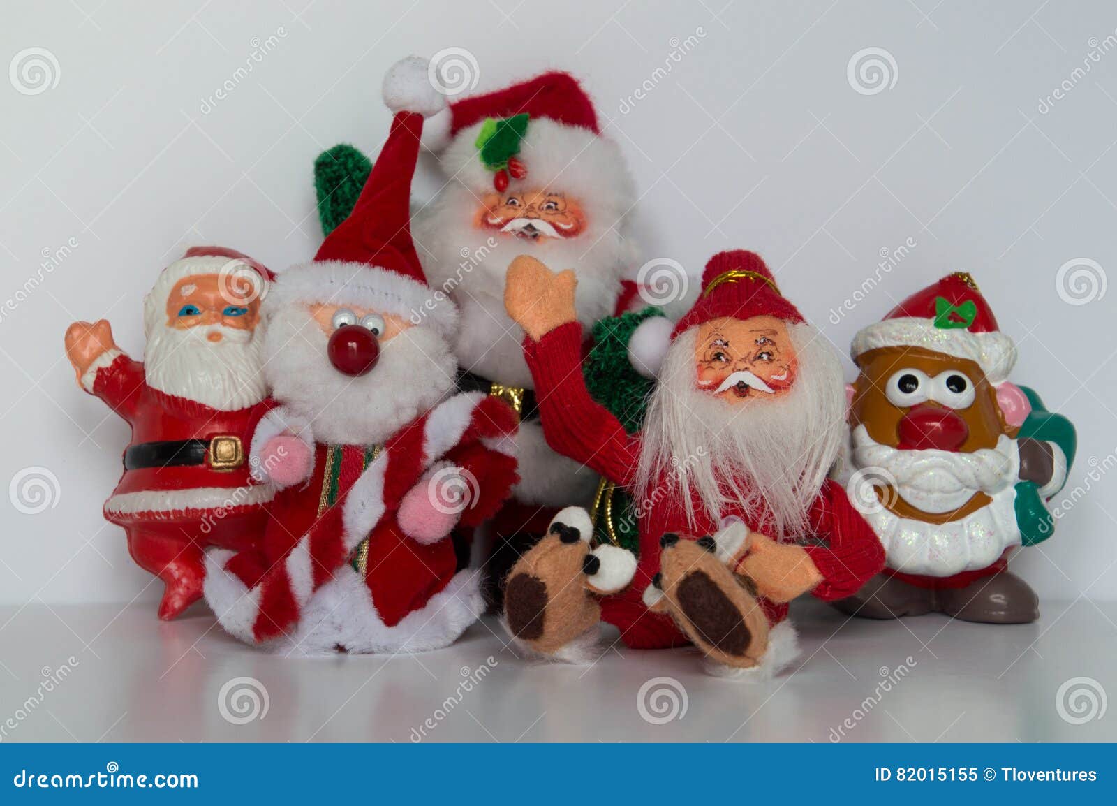 Five Santa Ornaments with Four Standing and One Seated, Waving at the ...