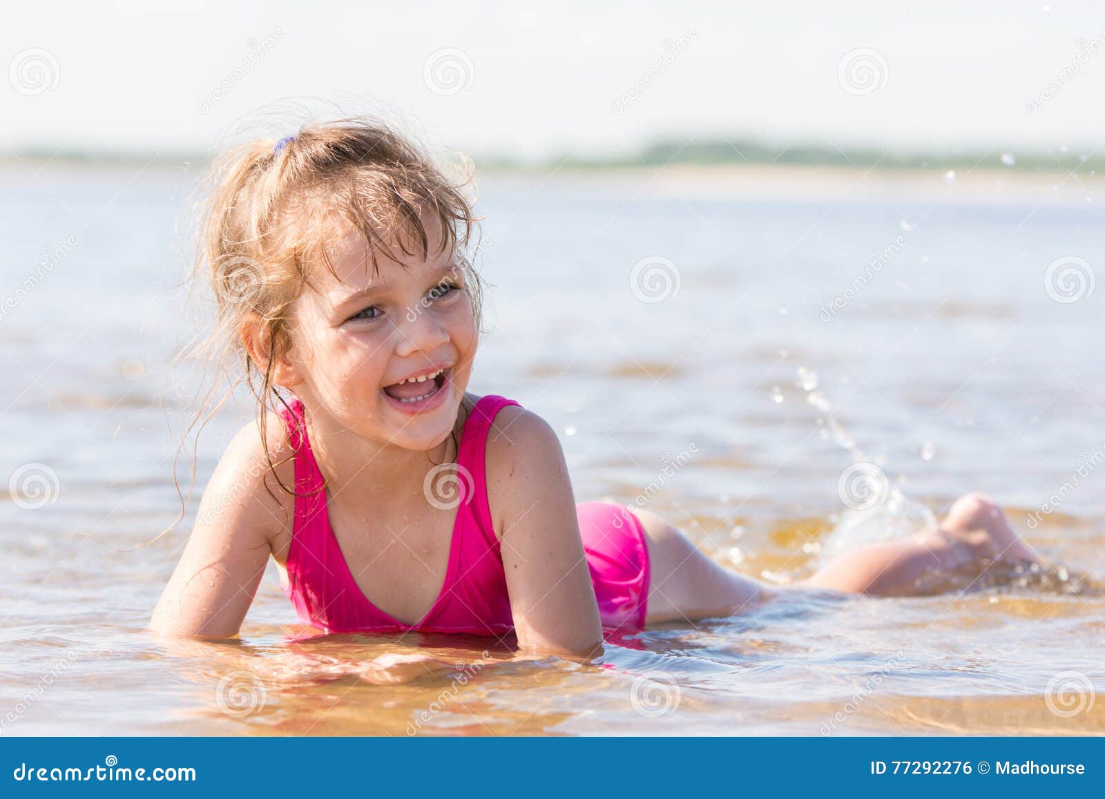 Five-year Girl Lies in Water in Shallows of the River, Laughing and ...
