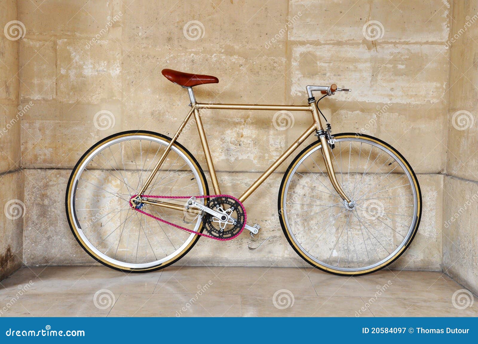 Vintage fixed gear bicycle with a pink chain