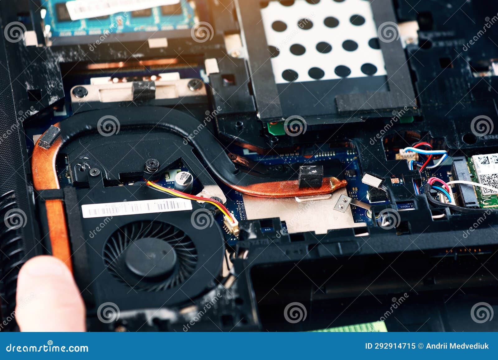 Fixing Laptop. Repairman Holds Cooling Fan and Repairs from Overheating