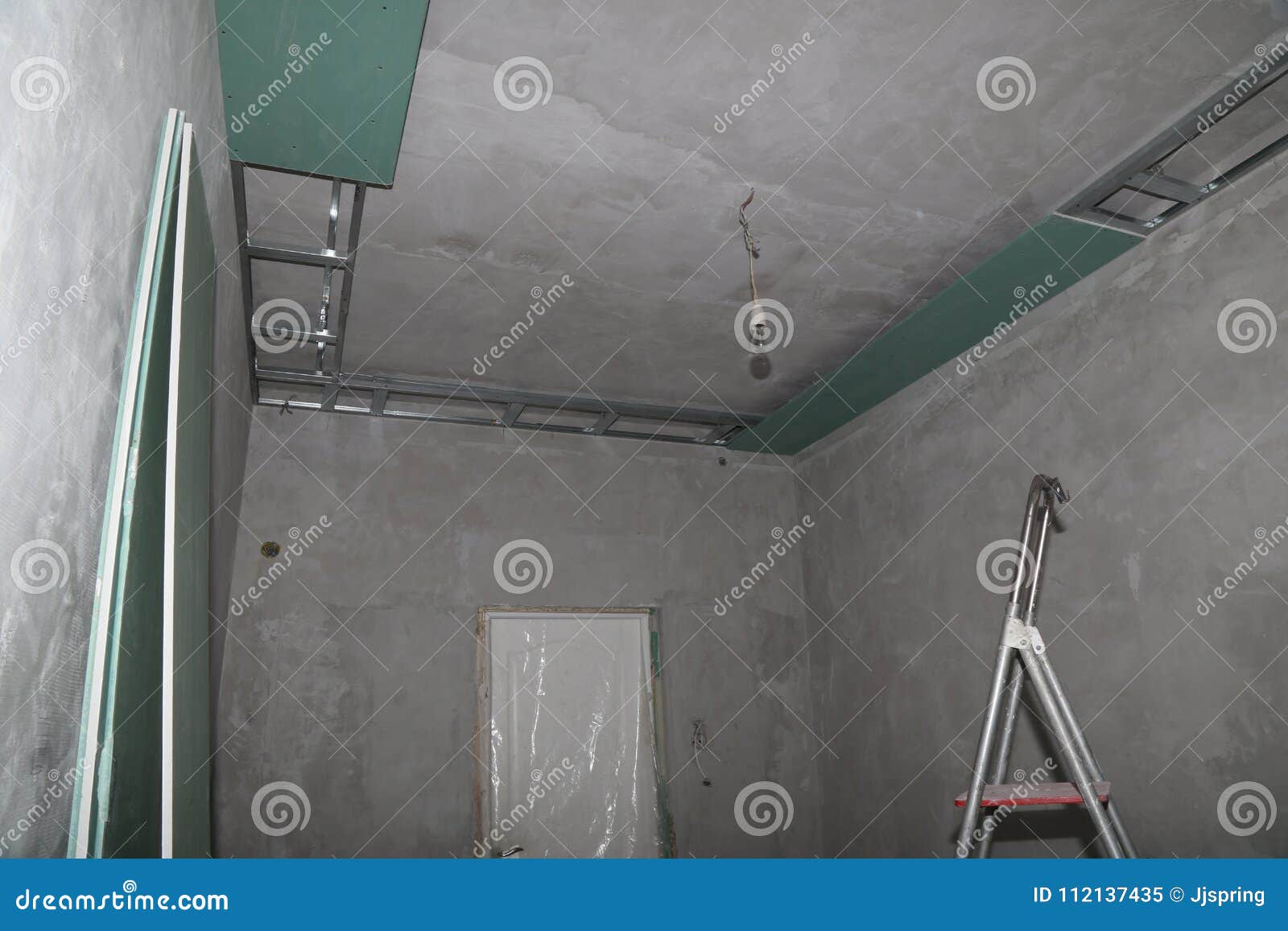 Fixing Plaster Boards At The Ceiling During Construction Stock