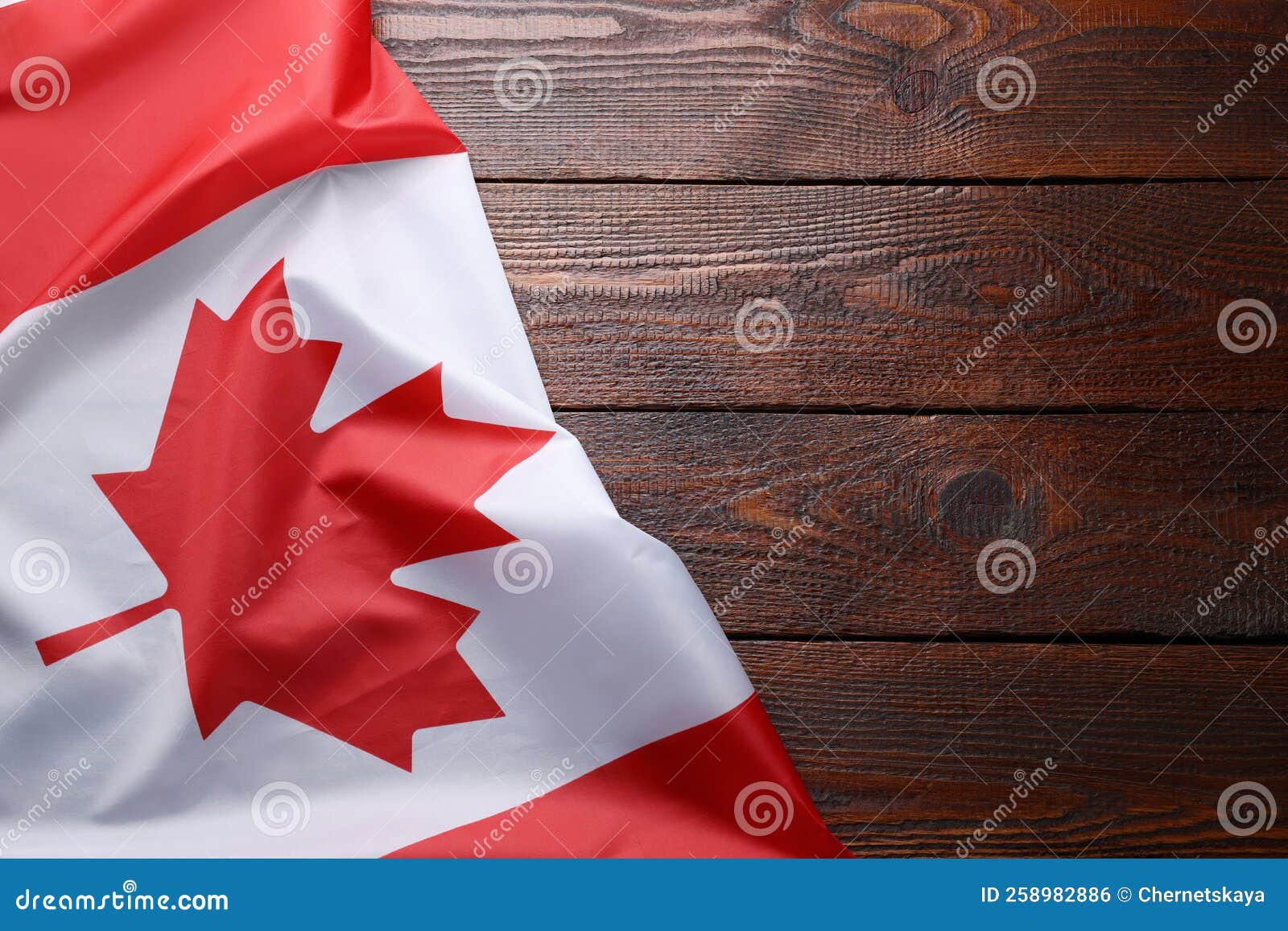 Flag of Canada on Wooden Table, Top View. Space for Text Stock Photo