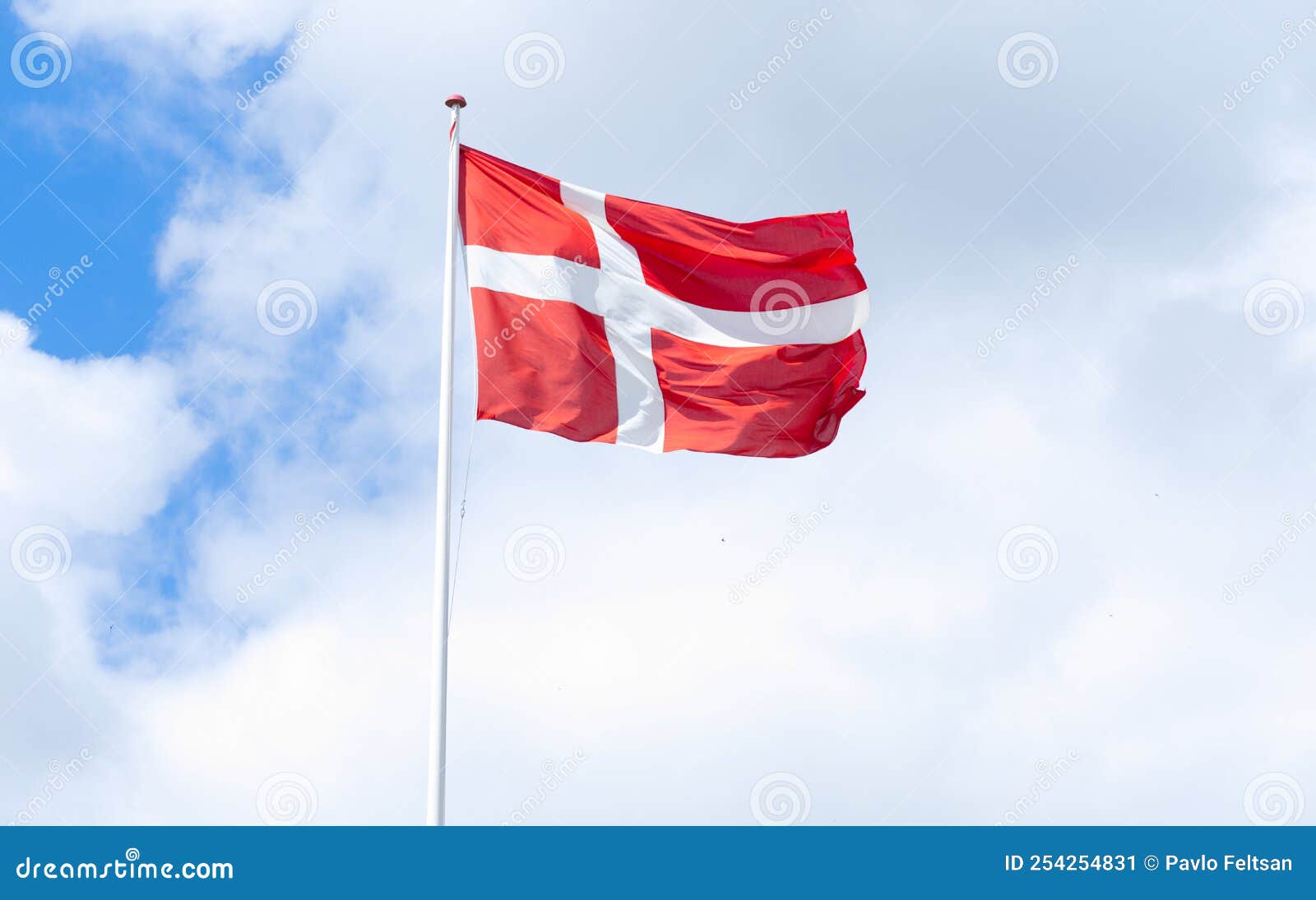 flag of denmark in a blue sky with clouds
