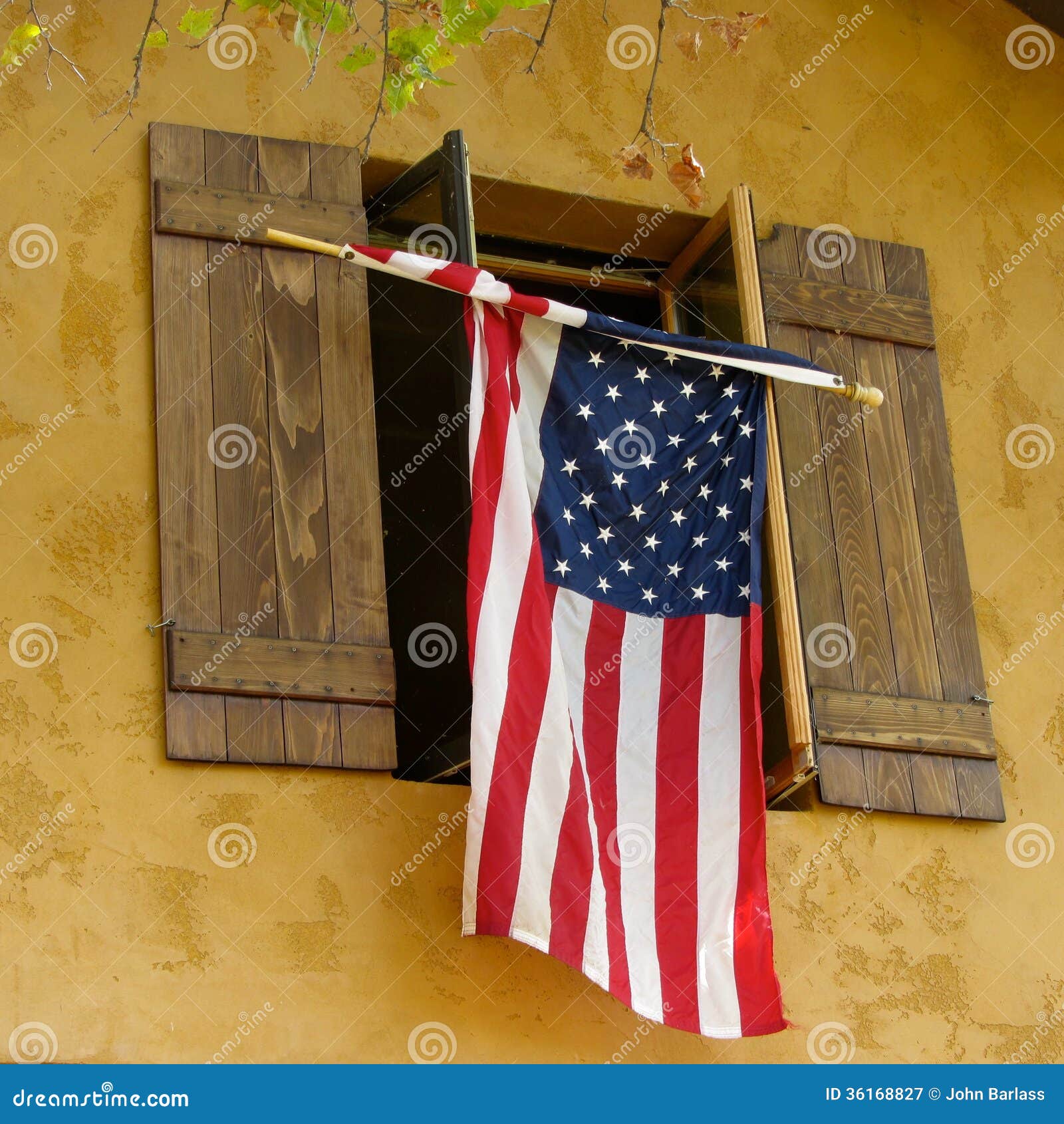 Flag hanging from shutters stock image. Image of patriotic 36168827