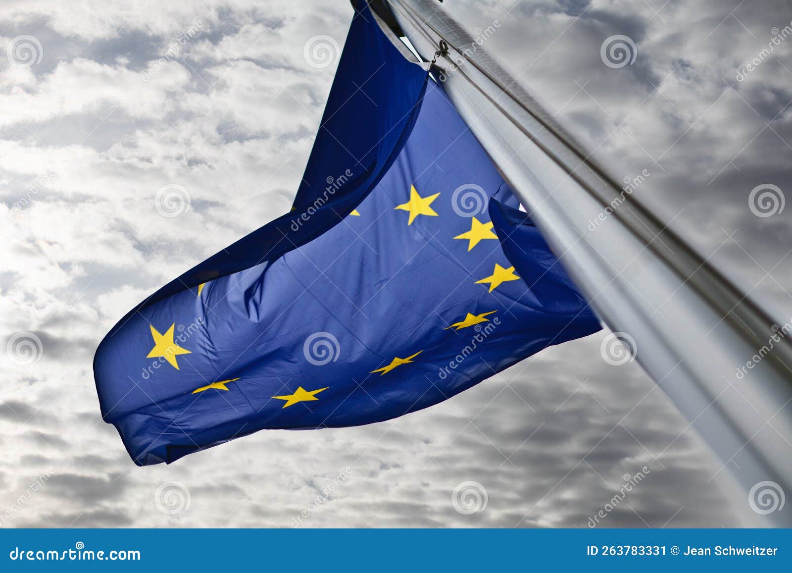 flags in the wind in front of the berlaymont building in brussels