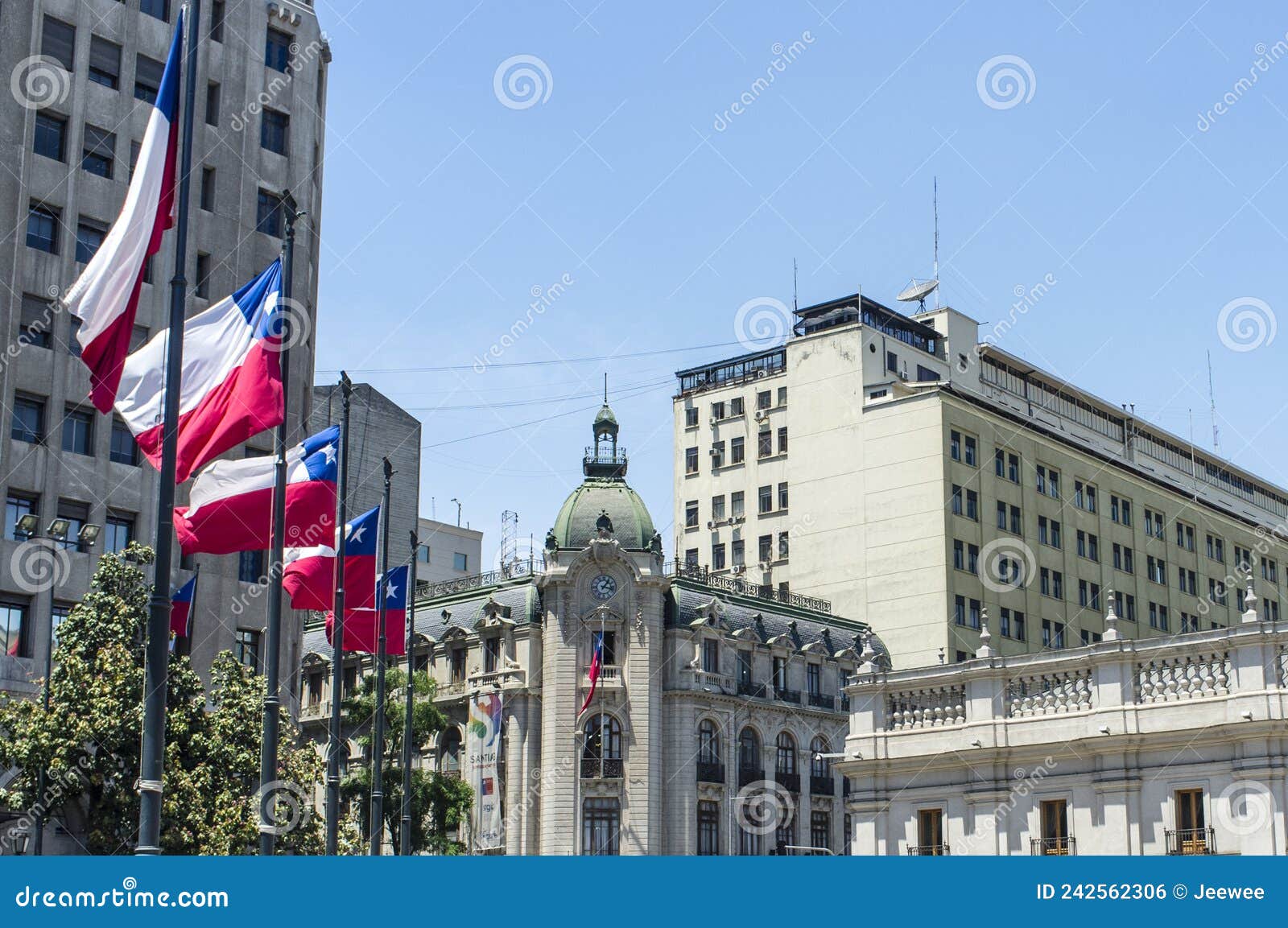 flags of chile in front of the presidential palace - palacio de la moneda - in santiago de chile, chile