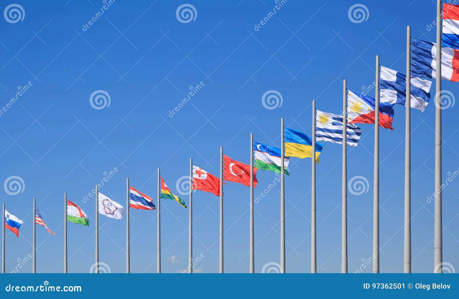 Flags of Many Countries Flutter on the Background of the Blue Sky in