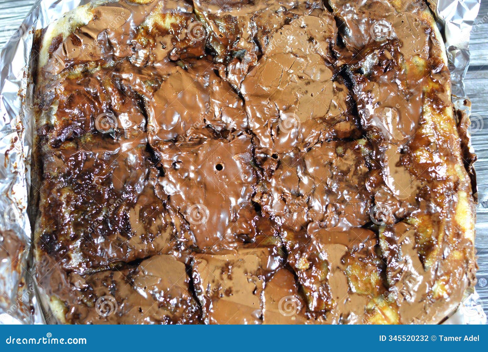 a flaky egyptian layered pastry, stuffed with chocolate baked dessert and cookies and topped with brown chocolate paste and sauce
