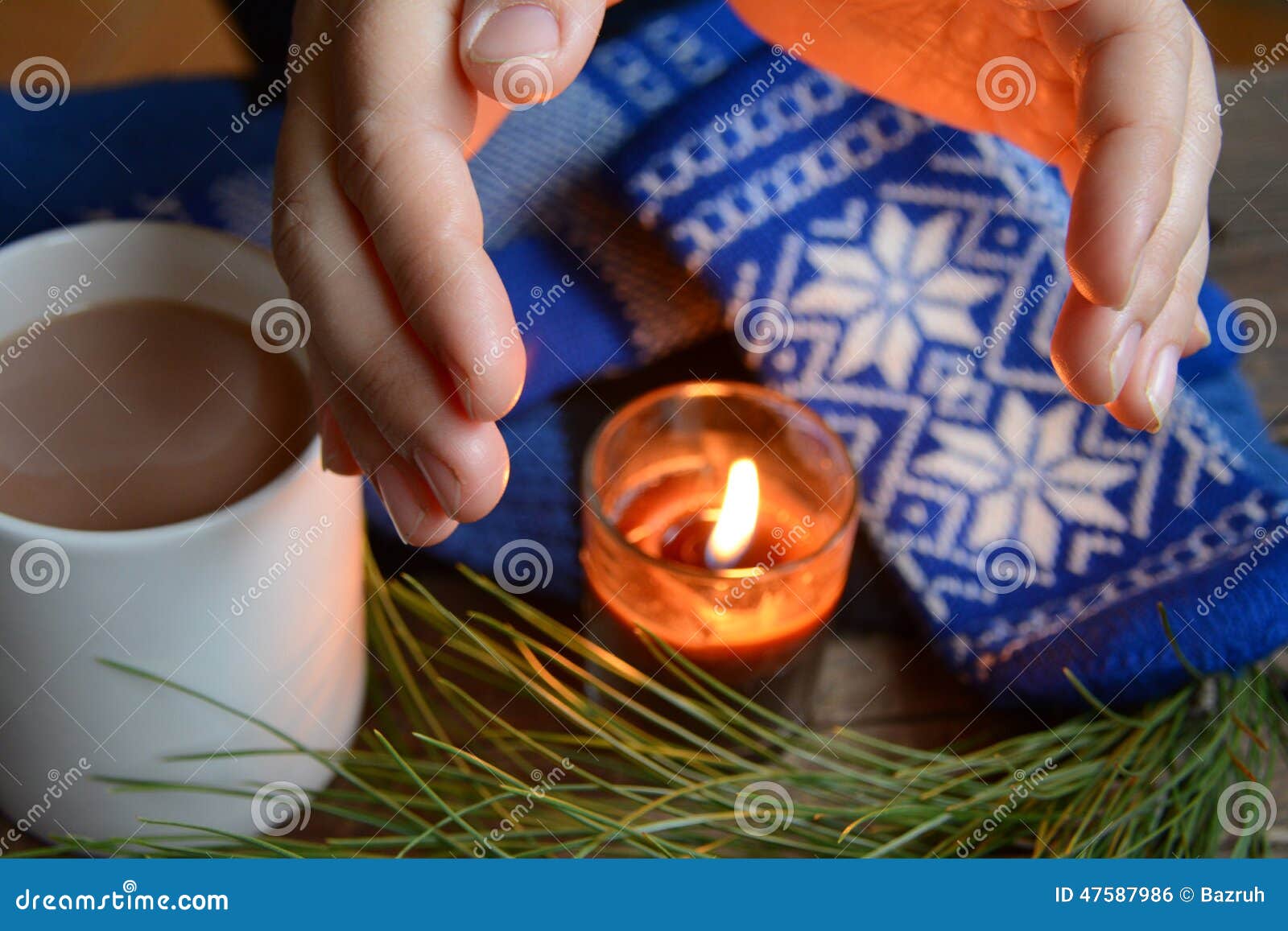 flame from a candle warms hands