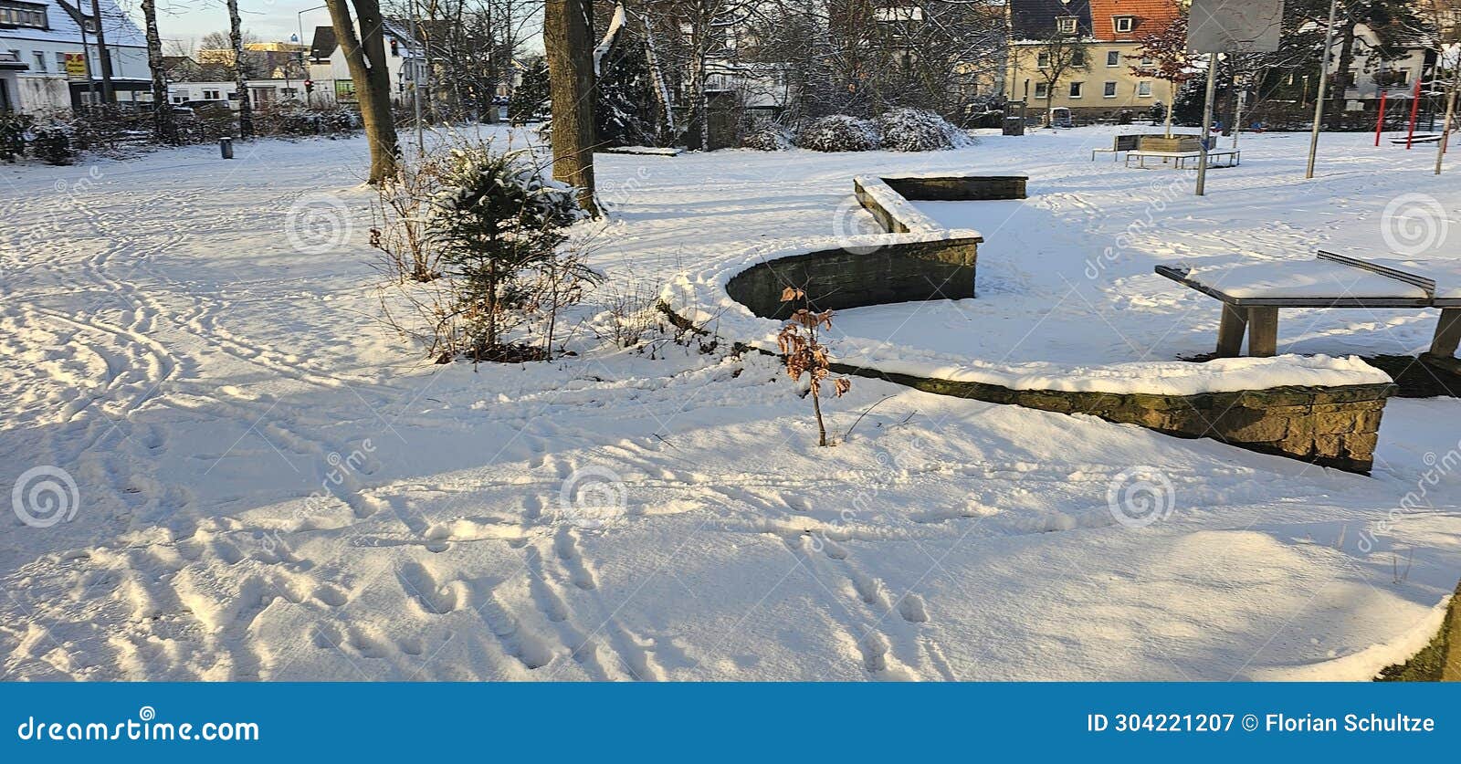 a flat field covered with deep snow and a person's footprints