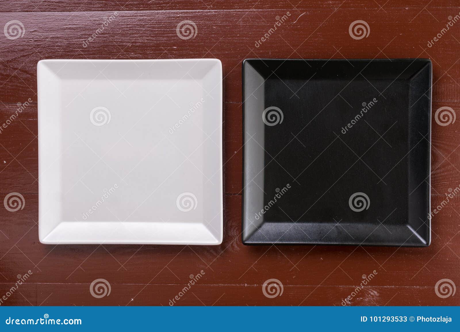 Flat Lay Above Black and White Square Plates on the Wooden Boards Table
