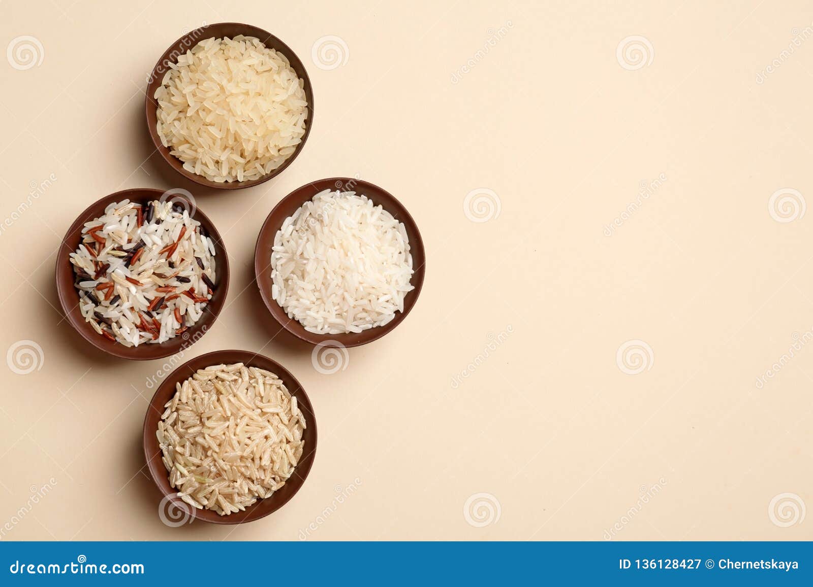 Flat Lay Composition with Brown and Other Types of Rice in Bowls on