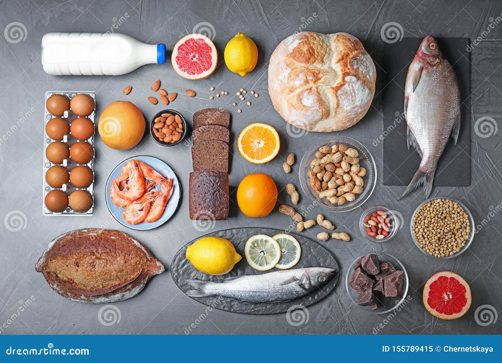 flat lay composition with different  on dark grey background. food allergy concept