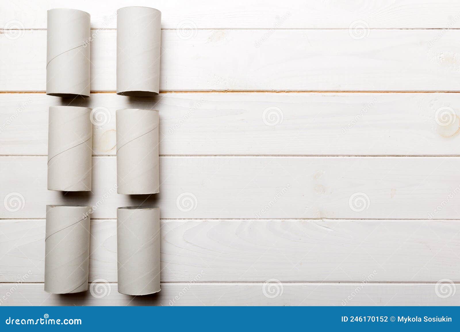 Flat Lay Composition with Empty Toilet Paper Rolls and Space for Text