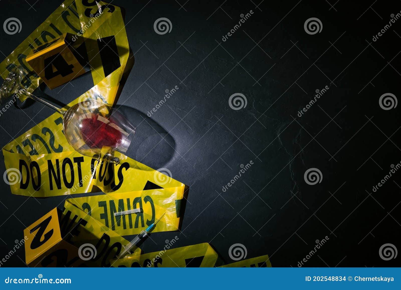 flat lay composition with evidences and crime scene tape on black slate background, space for text