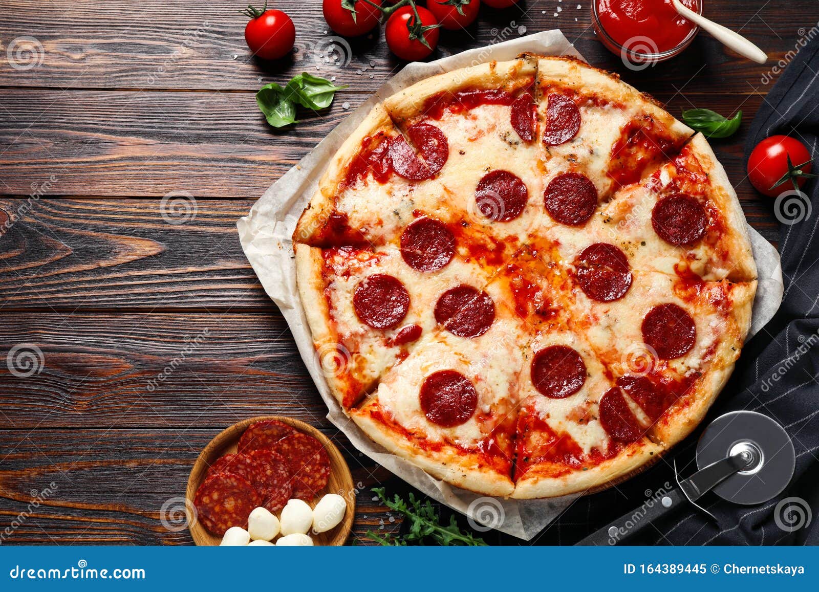 Flat Lay Composition with Hot Pepperoni Pizza on Wooden Table Stock