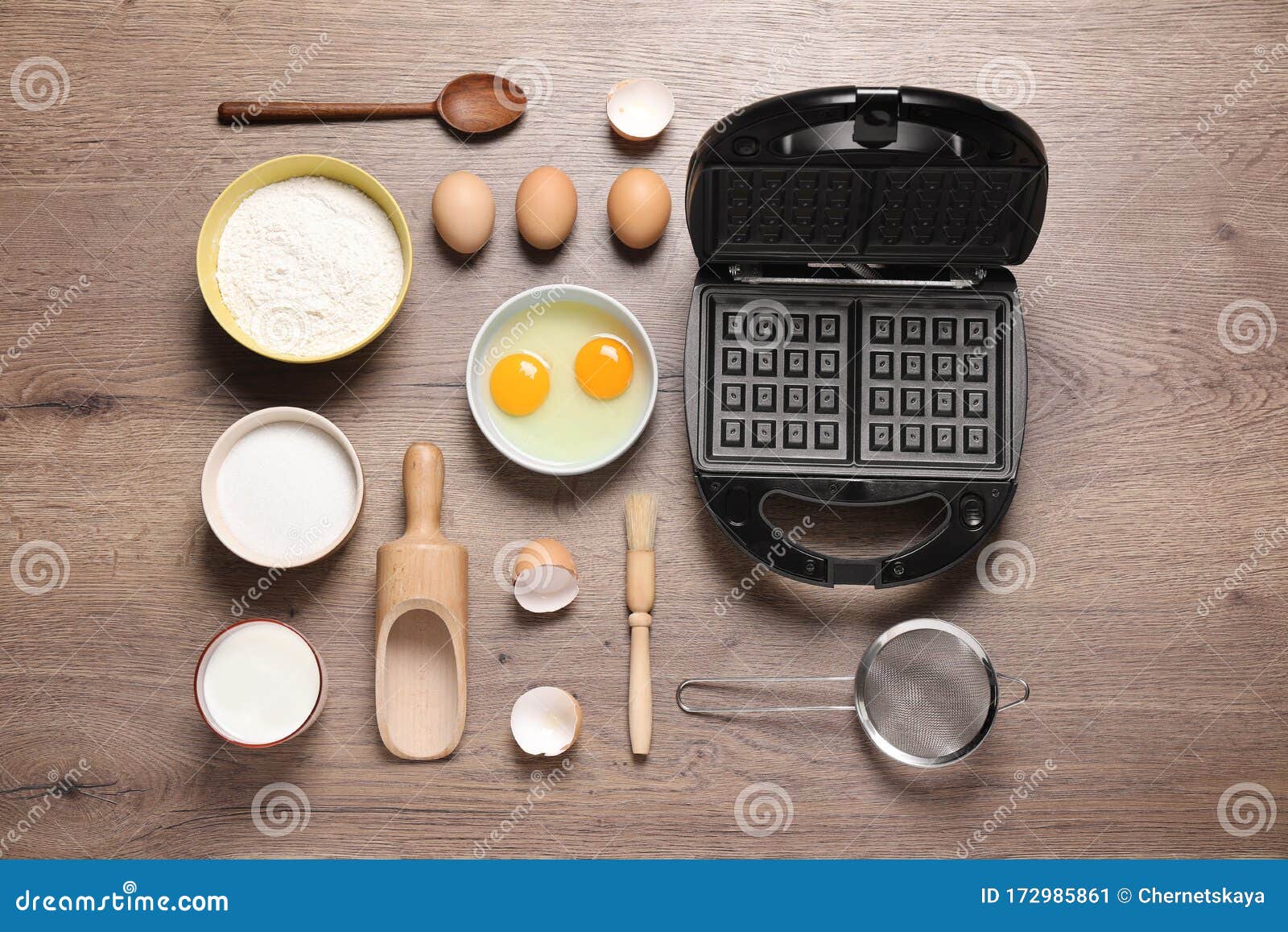 Flat Lay Composition with Ingredients and Belgian Waffle Maker on Table