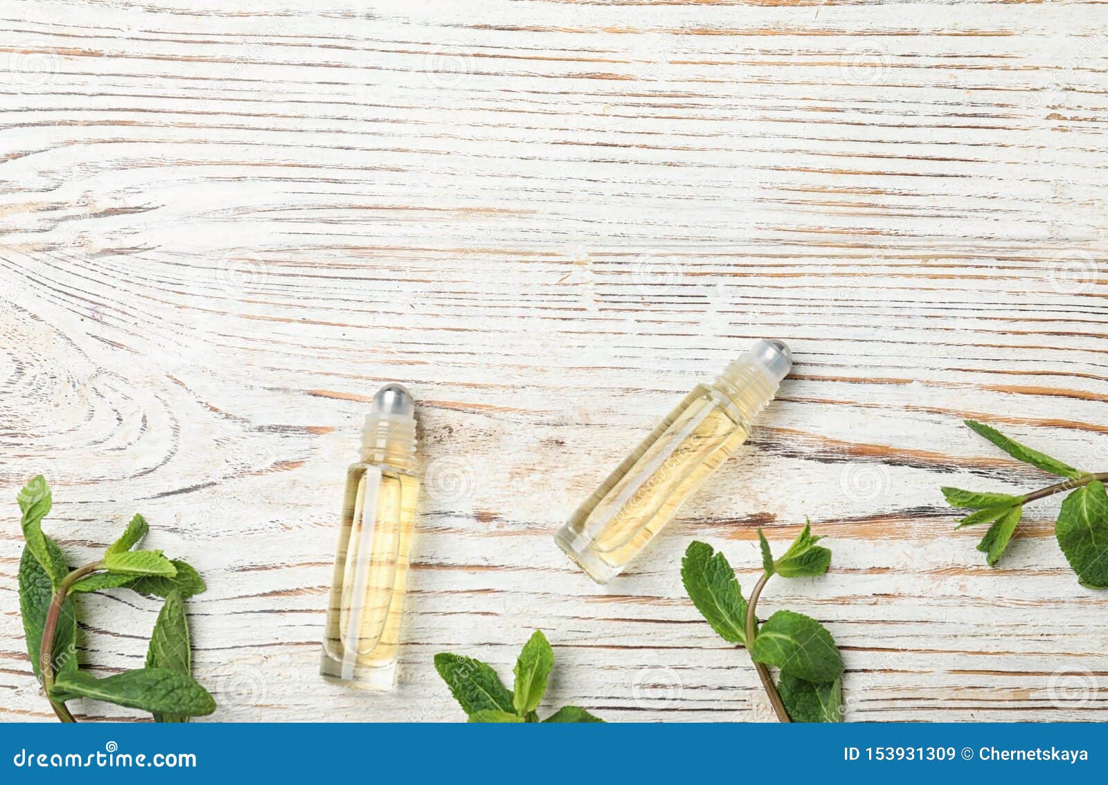 Flat Lay Composition with Mint Essential Oil on White Wooden Background