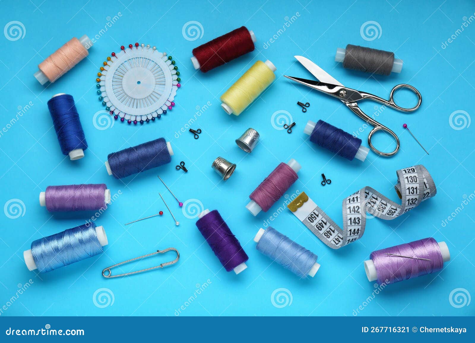 Flat Lay Composition with Thimbles and Different Sewing Tools on Light