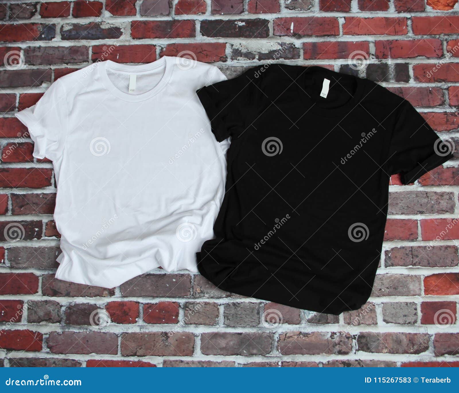 flat lay mockup of white tshirt and black tshirt on brick background