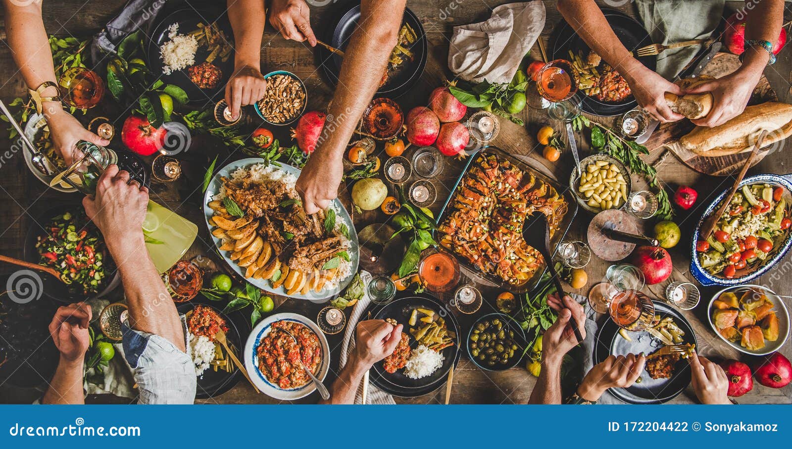 flat-lay of peoples hands and turkish foods over rustic table