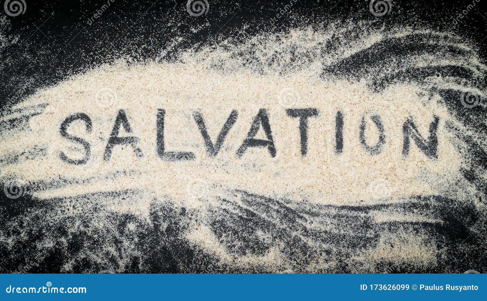 flat lay of salvation word written on white sand