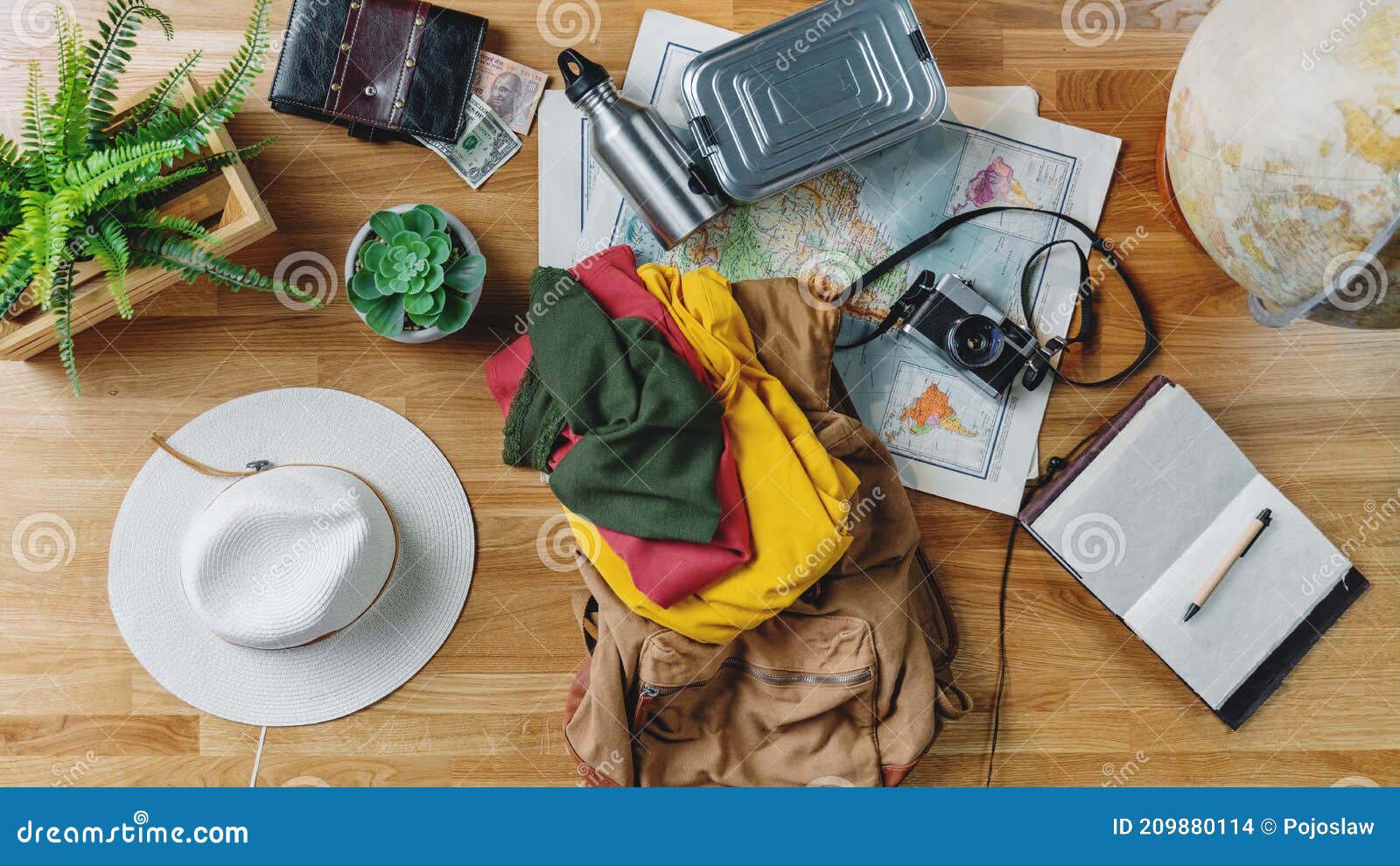 flat lay top view desktop with maps and other travel essentials, packing and travel concept.