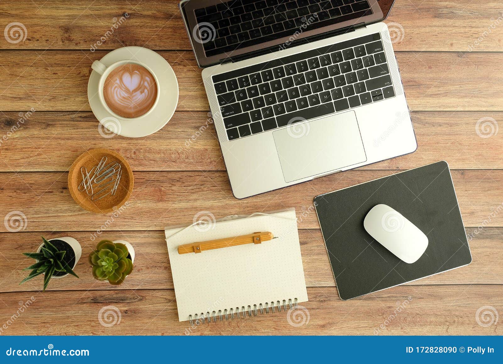 flat lay workspace. woman hand with coffee cup, smartphone, computer, notebook, planner and stationary with copy space on marble