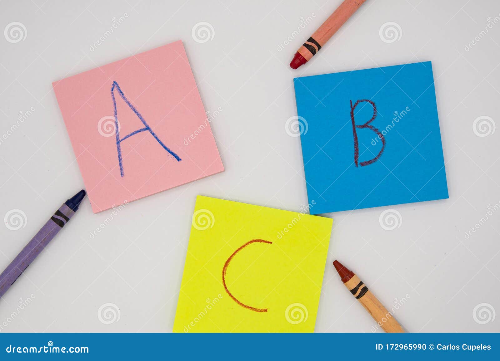 Flat Top View of Notepads with Letters Written in Crayon on Them Stock
