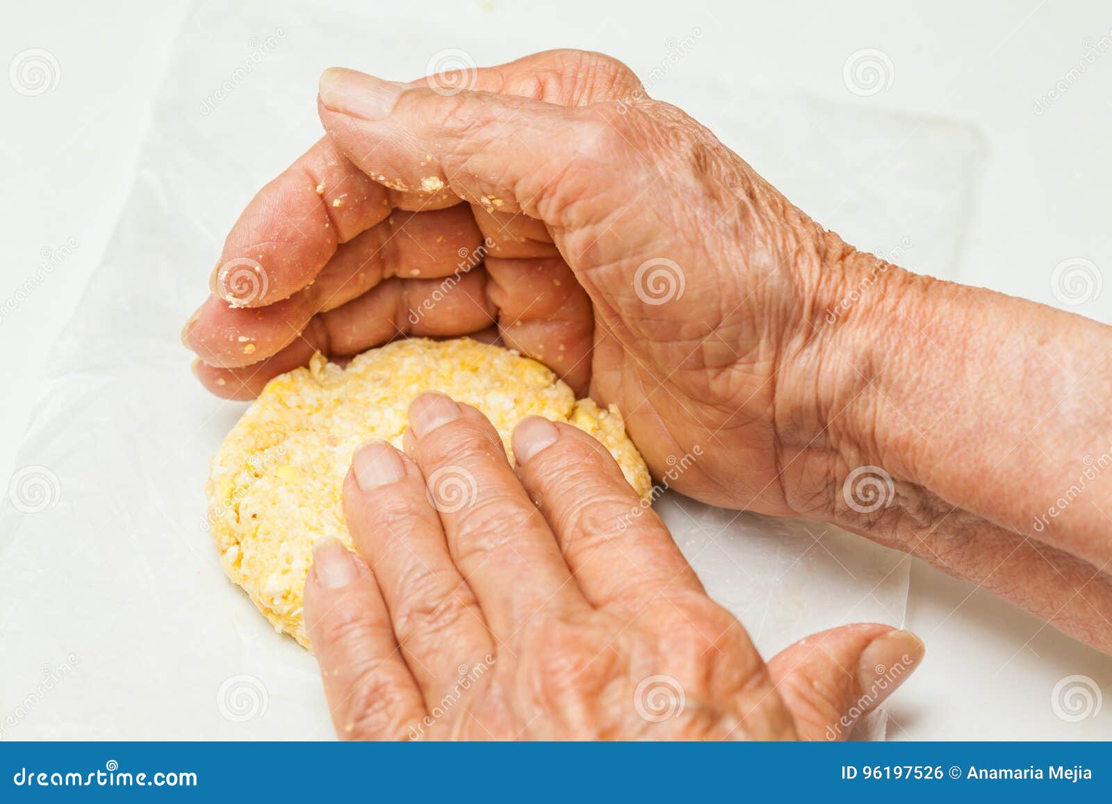 flatten the dough balls to form the arepa typical 