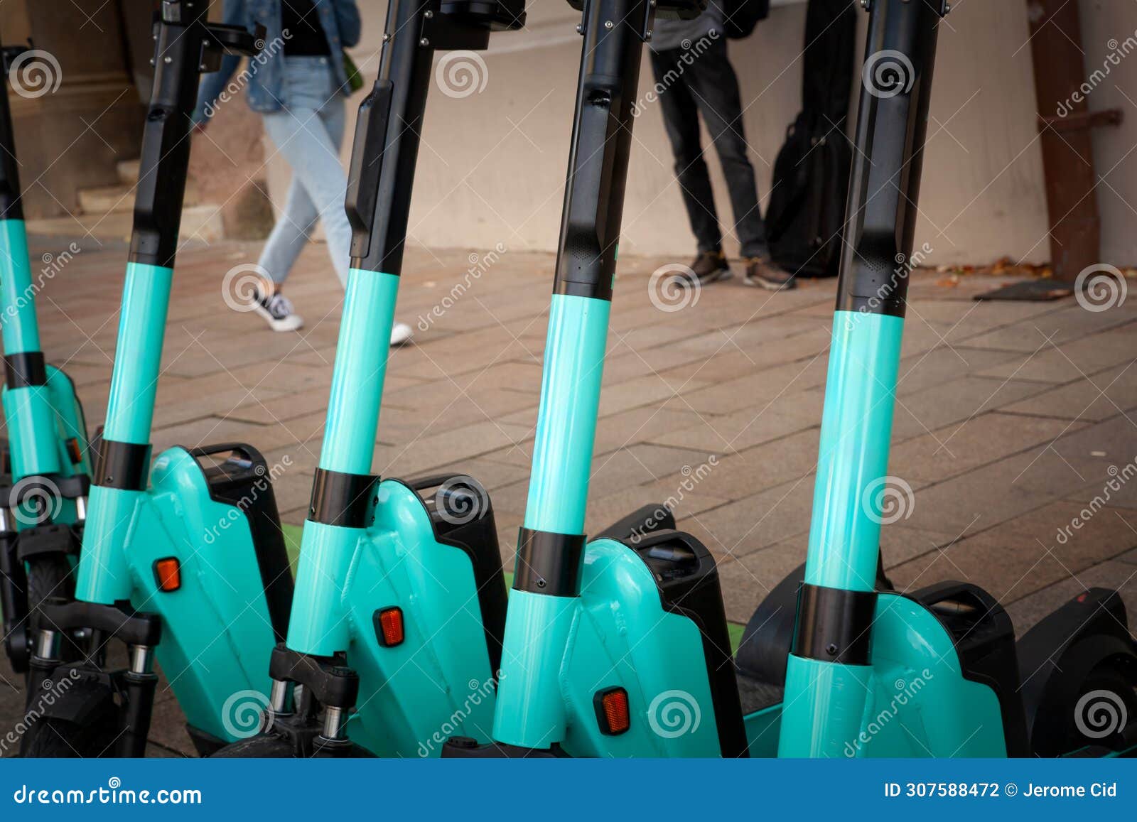 a fleet of dockless electric scooters for rent, lined up on a european city street, offering an eco-friendly, convenient & modern