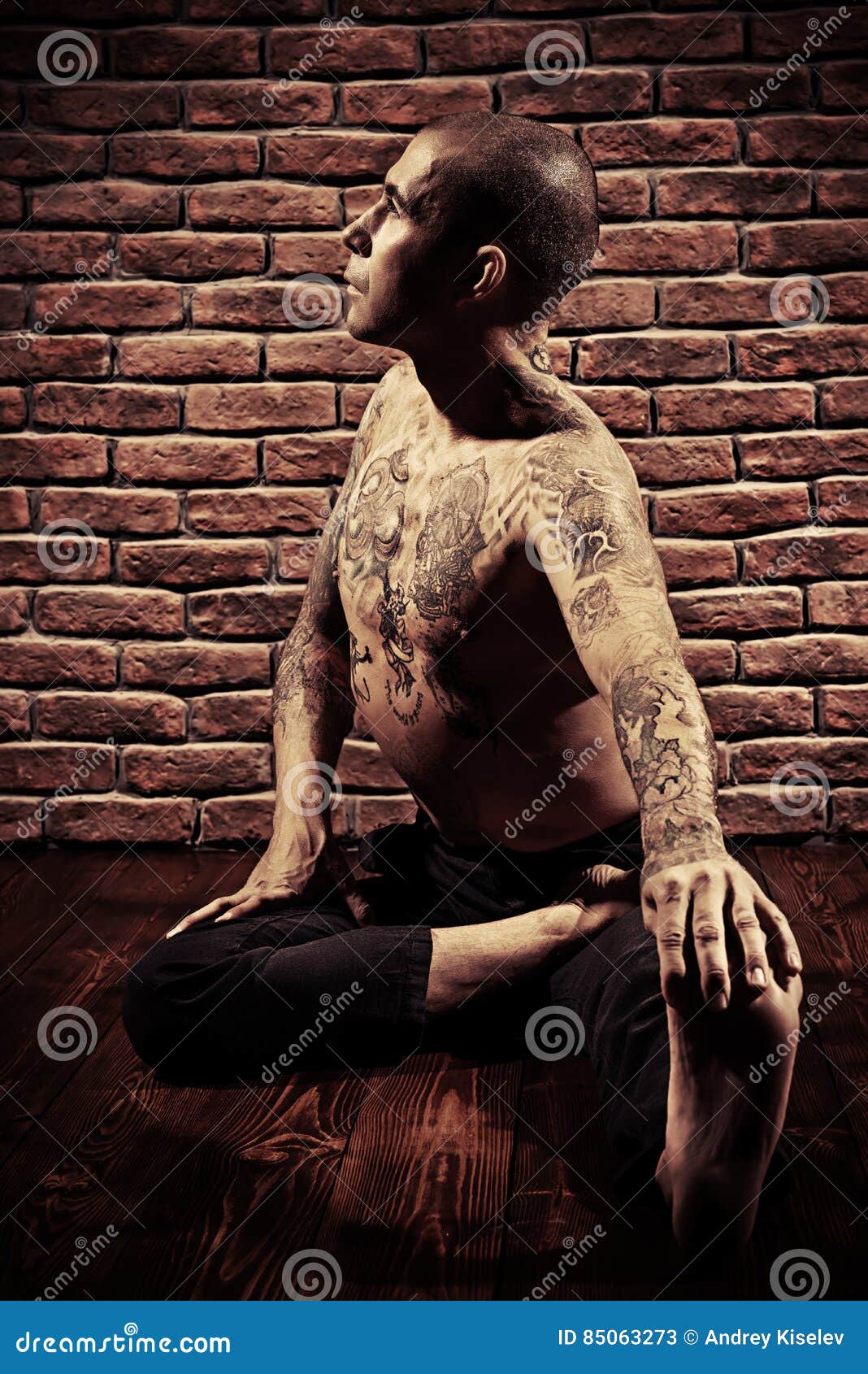 Wall Mural Flexible man posing in difficult yoga pose 