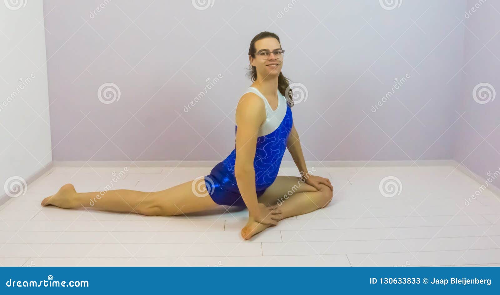 Acrobatic Gymnast Is Arching Her Back On The Beach Stock Image