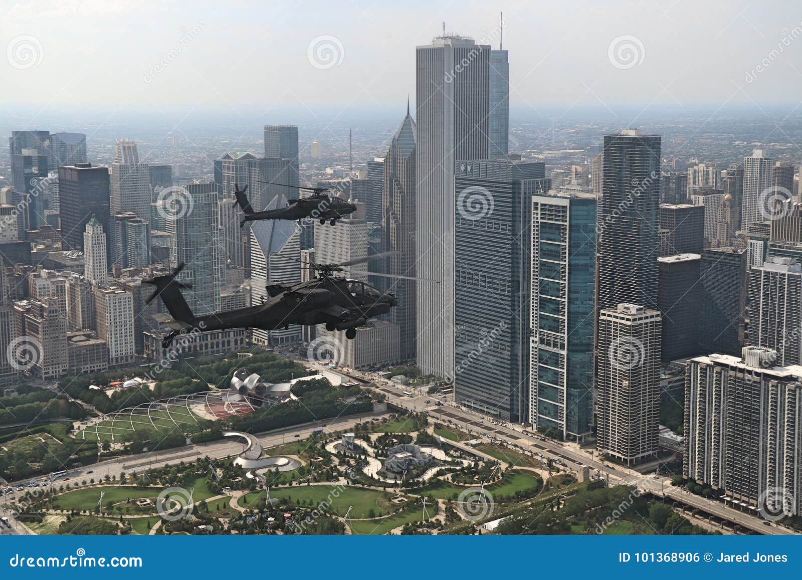 A Flight of Apache Helicopters Fly Over Downtown Chicago Editorial