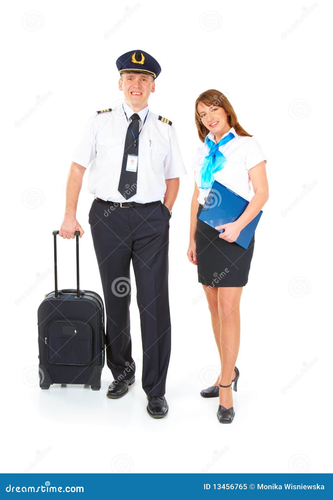 Flight crew. Cheerful pilot with trolley bag in hand and smiling ...