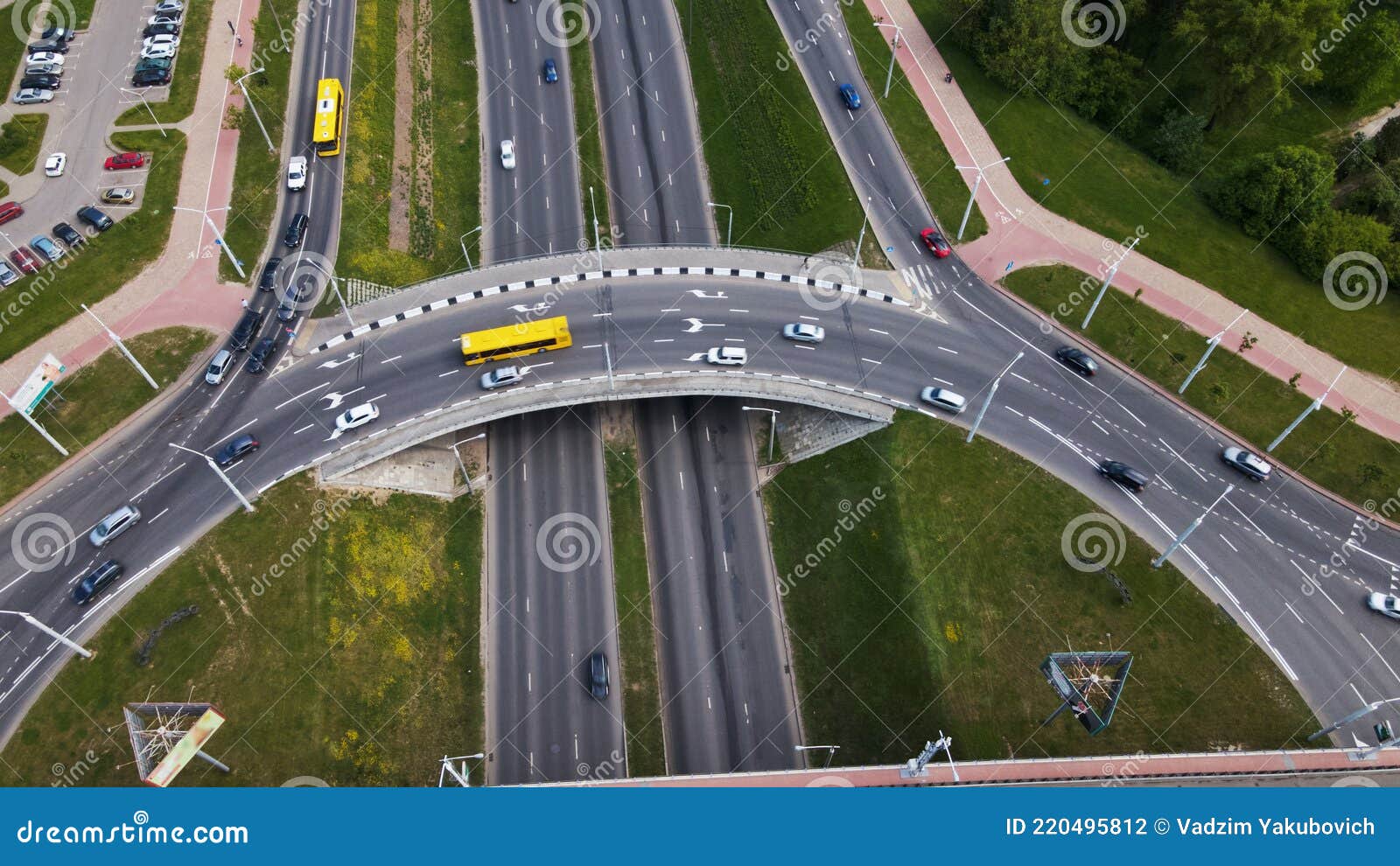 flight over a multi-level road junction. public transport is visible. city aerial photography