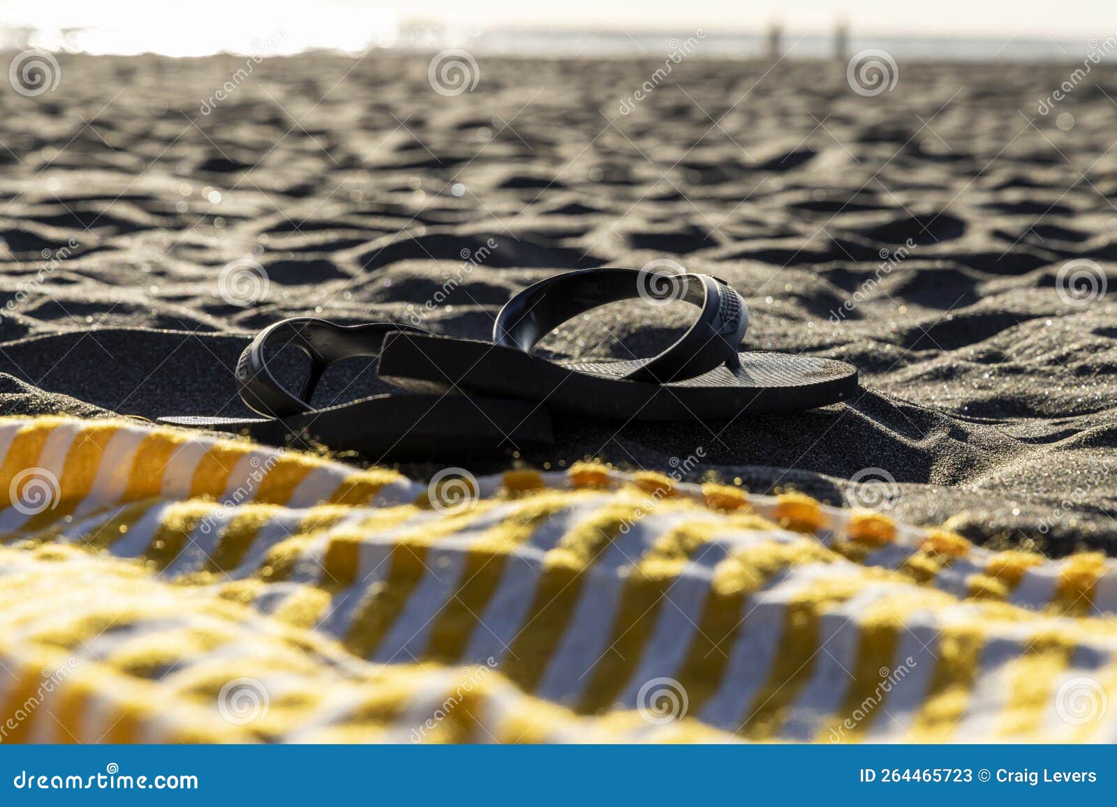 flip-flop sandals on black sand