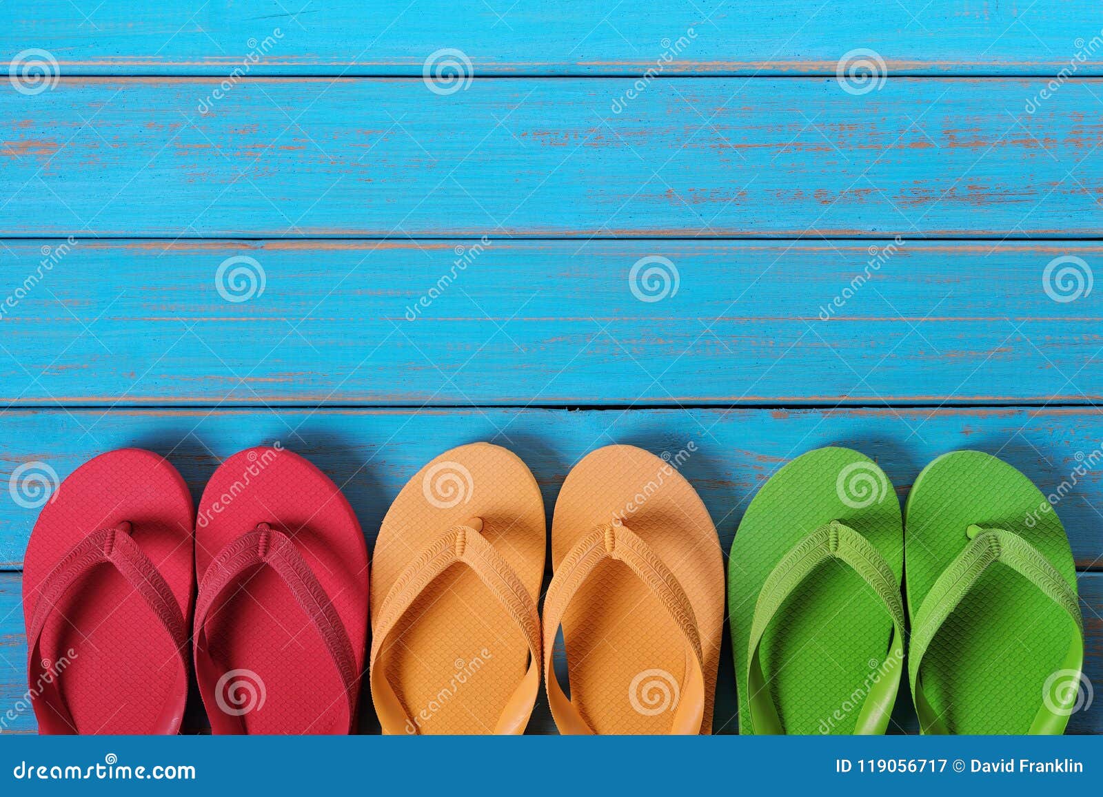 Flip Flops in a Straight Row Old Weathered Blue Beach Wood Background ...