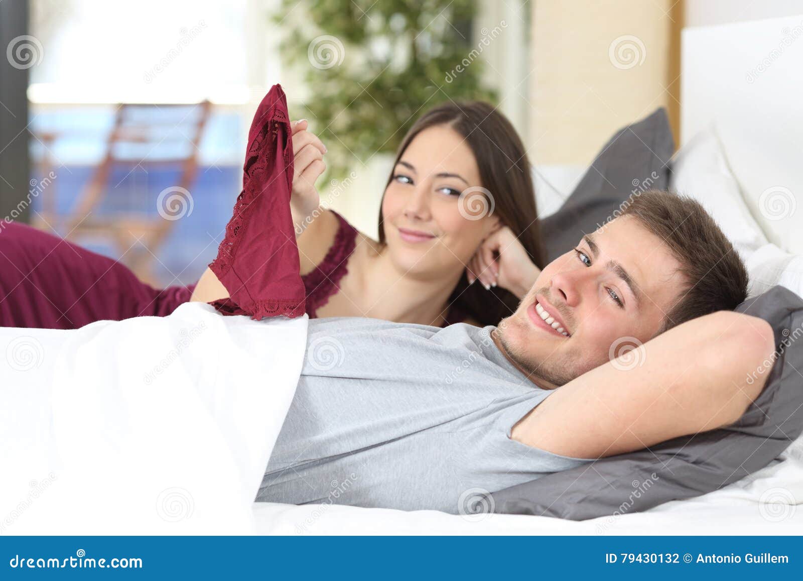 Flirtatious Man on the Bed with a Woman Stock Photo picture