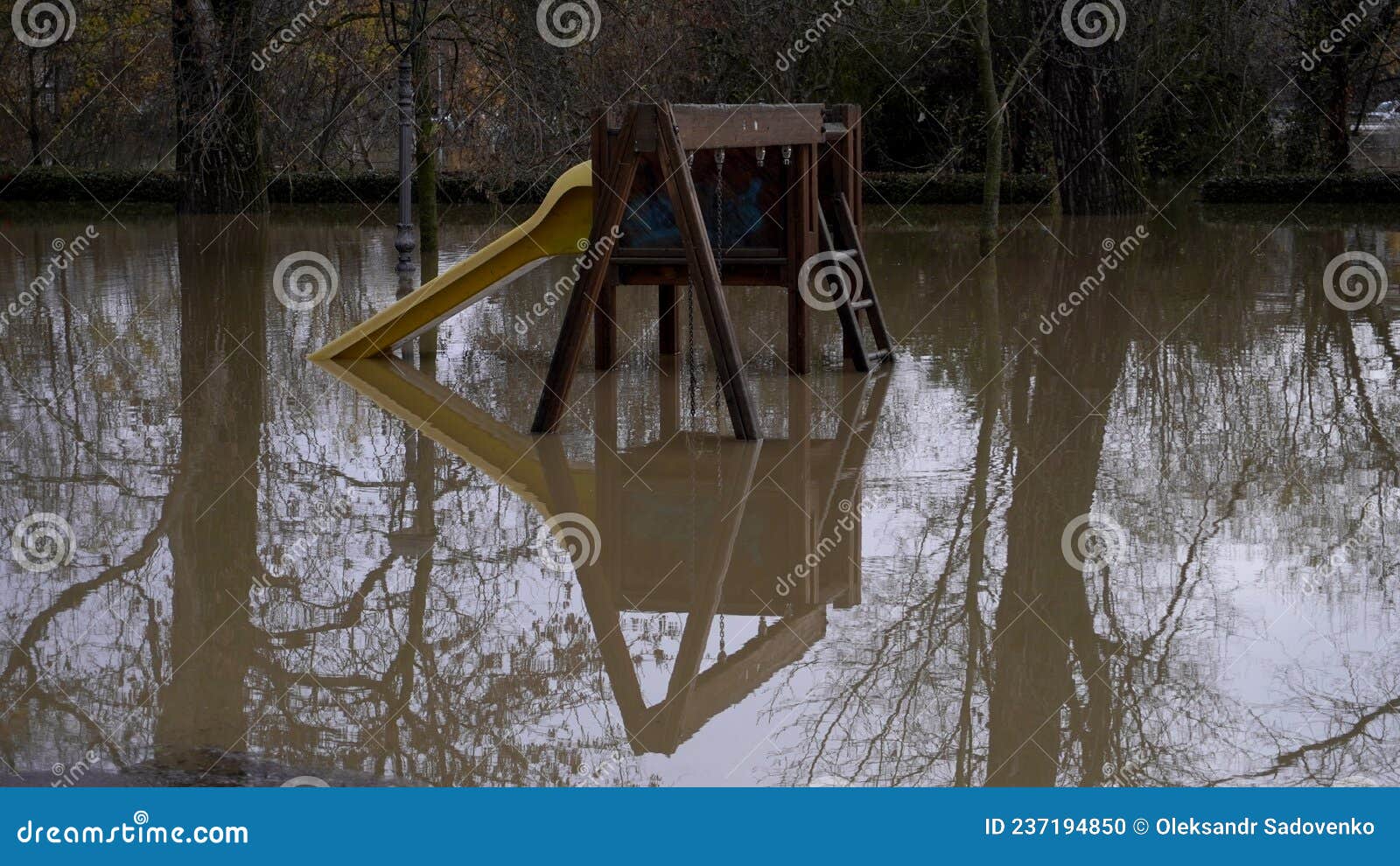 flood, children's swing is flooded with water.