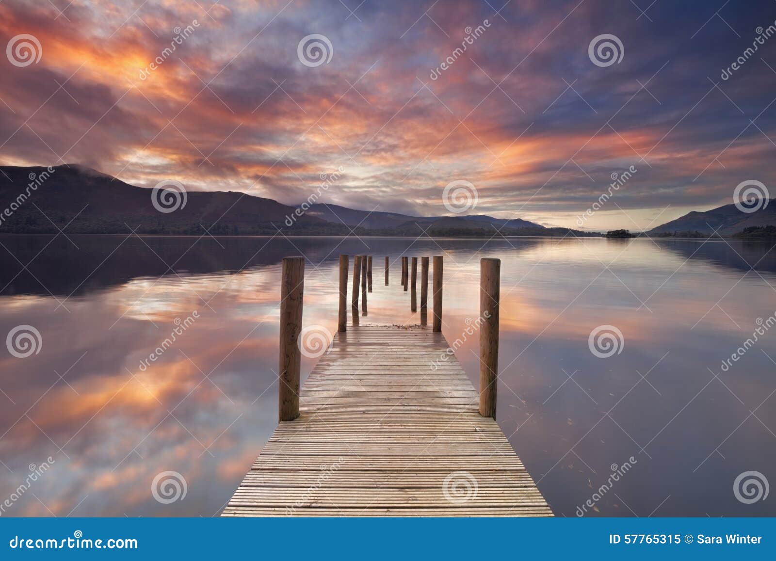 flooded jetty in derwent water, lake district, england at sunset