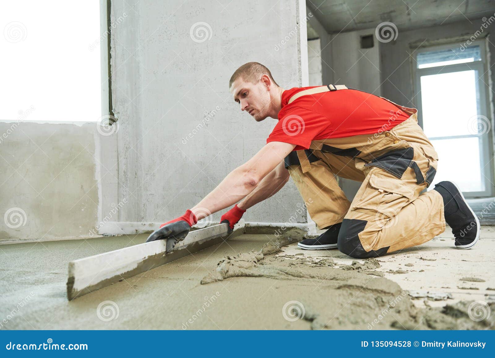 Floor Cement Work. Plasterer Smoothing Floor Surface with Screeder