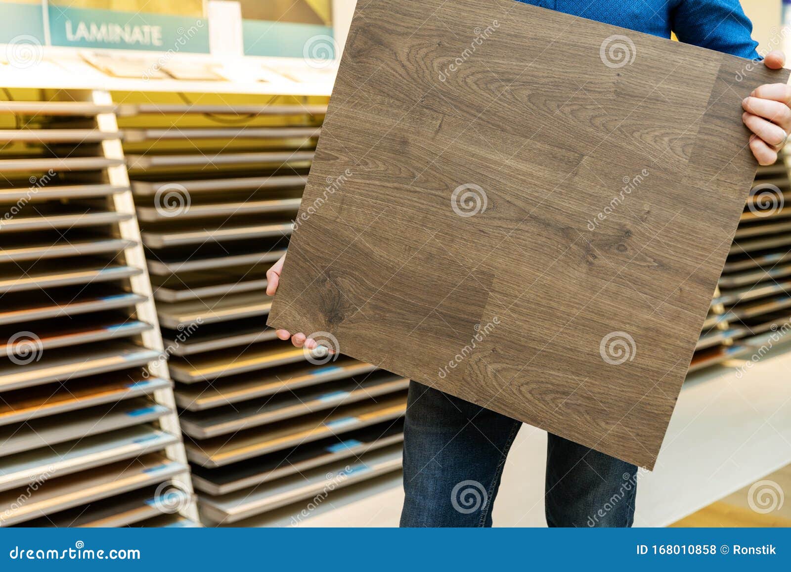 Flooring Shop Salesman with Laminate Floor Sample Panel Stock Photo
