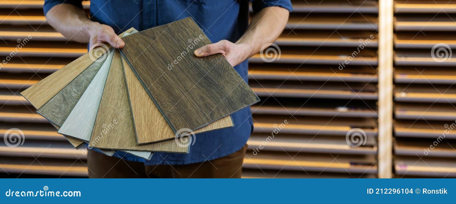 Flooring Store Seller with Vinyl Floor Samples in Hands. Copy Space