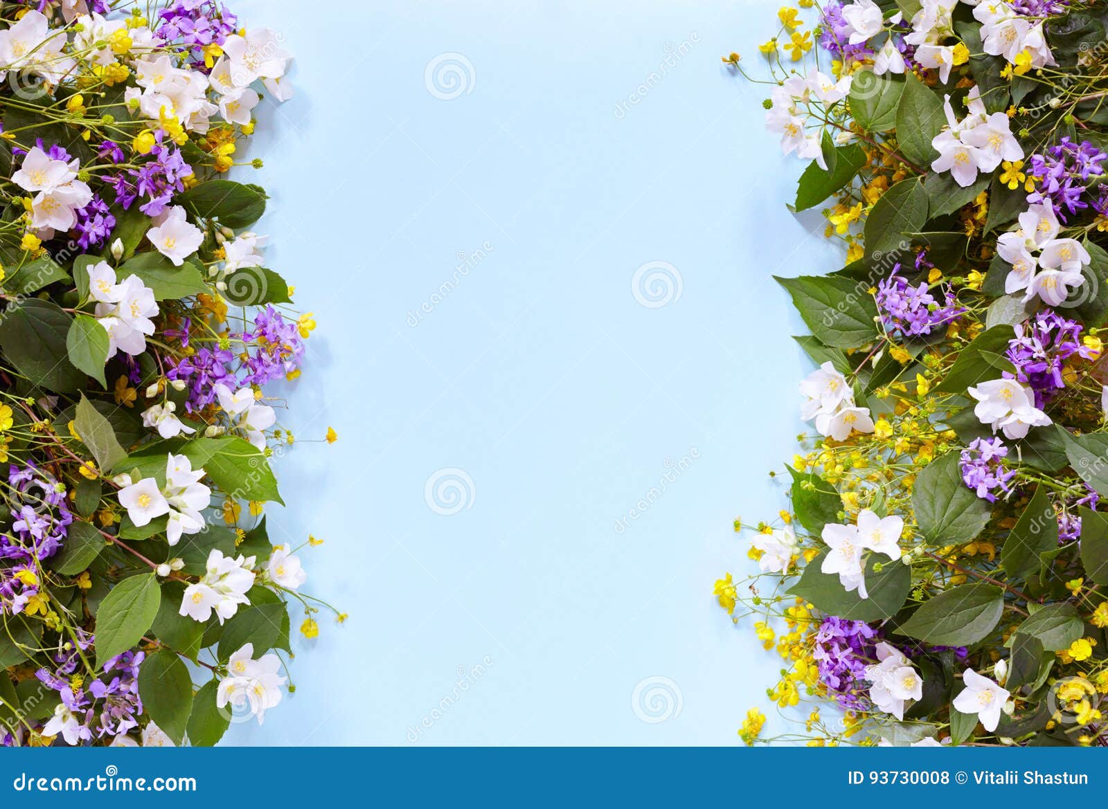 floral summer background on a blue table with wildflowers and jasmine. view from above. summer mood.