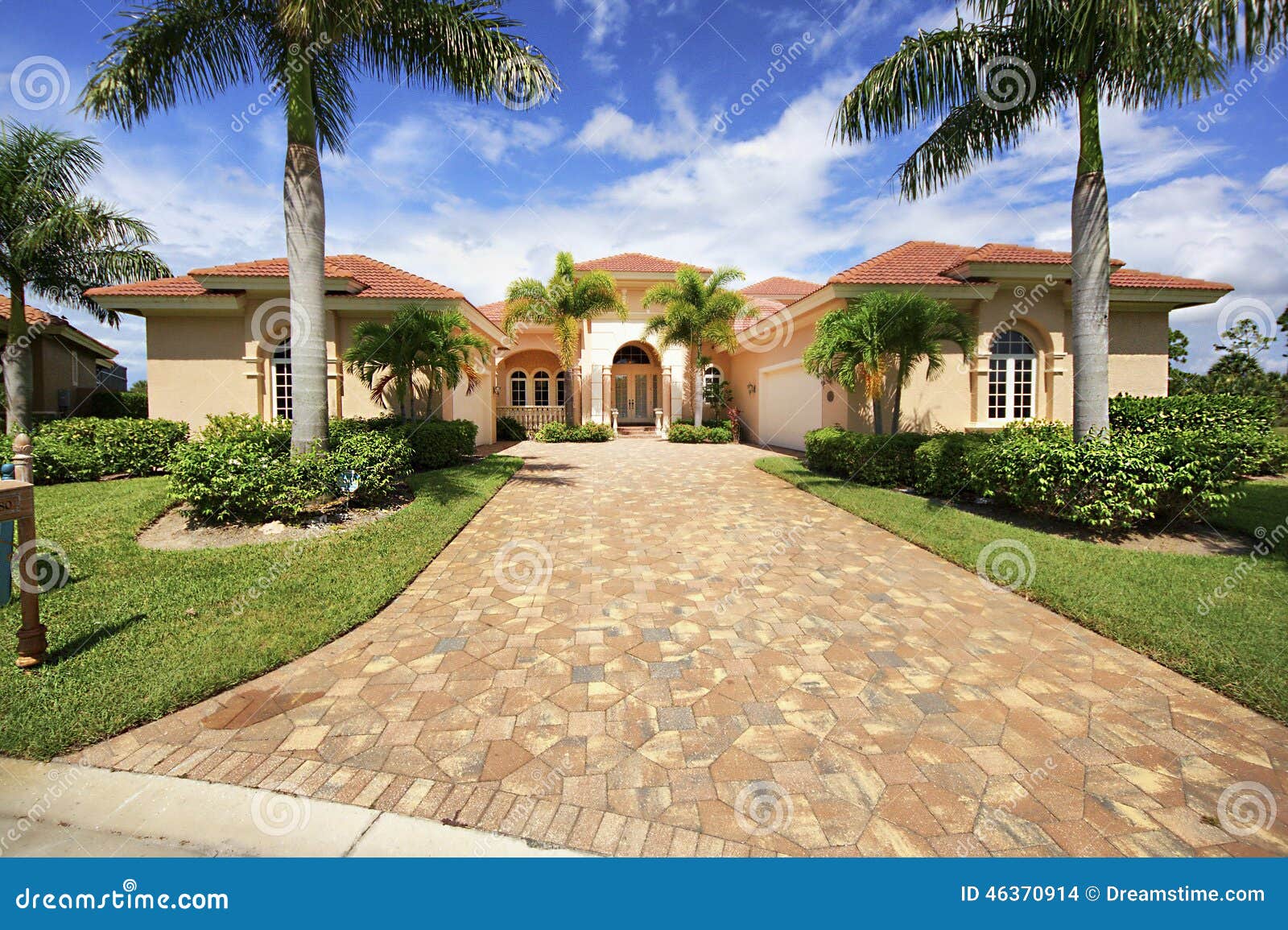 florida luxury home with paver block driveway