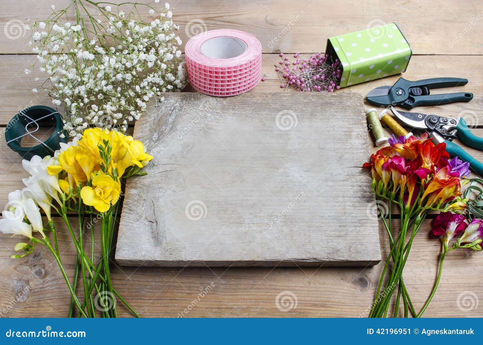 florist at work. woman making bouquet of spring freesia flowers