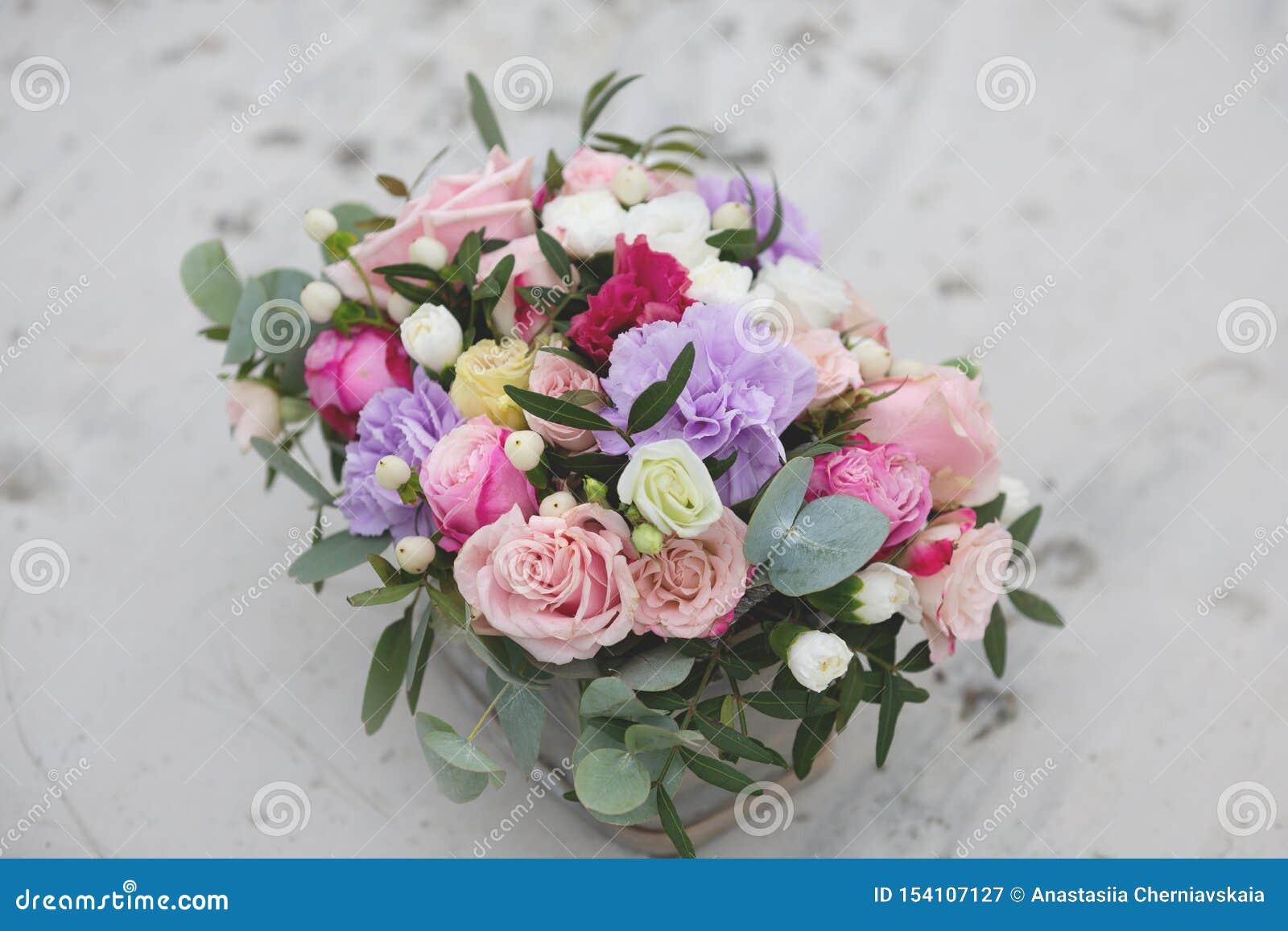 flower arrangement in a box with spray pink roses, succulent, eustoma, white hypericum, eucaliptus