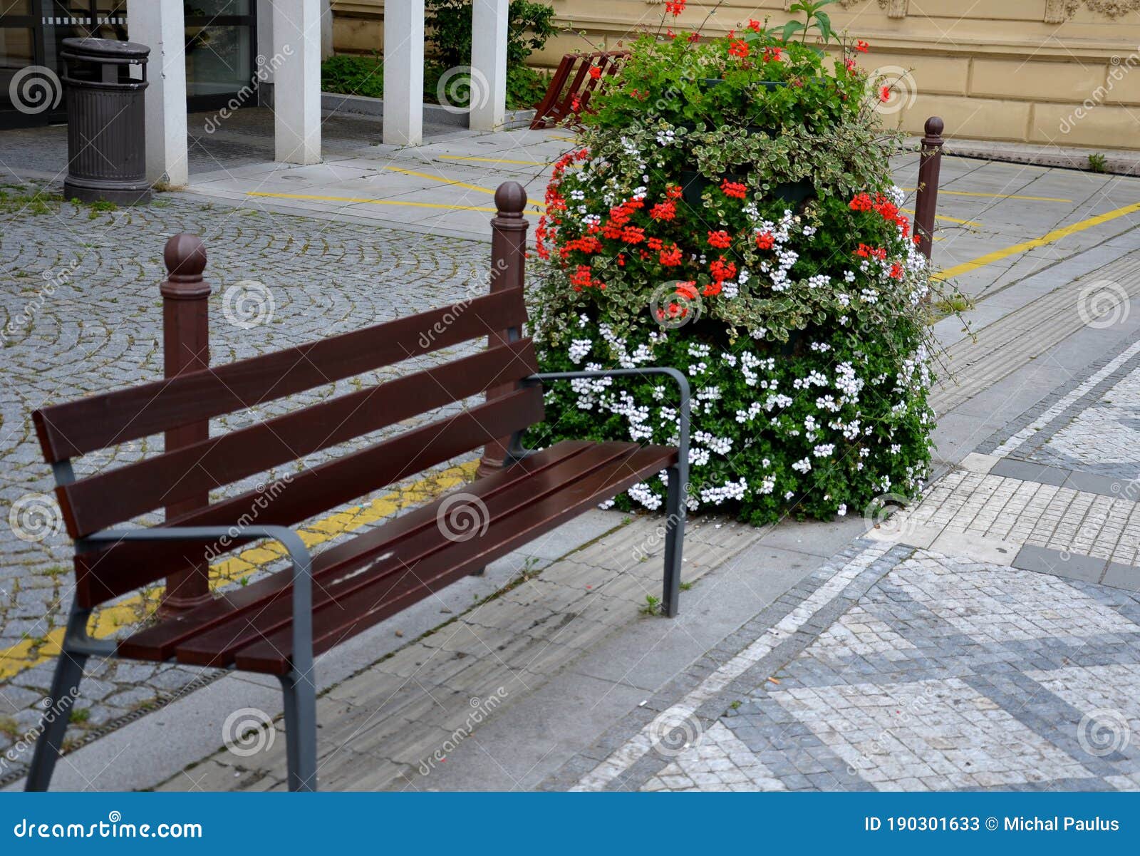 flower pyramid in the urban environment in the pedestrian zone blooms red and white annuals this is a seasonal ornamental column